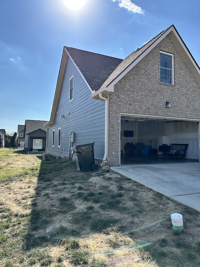 view of side of property with a yard and a garage