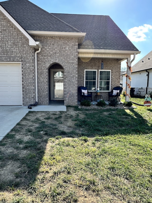 exterior space with a garage and a lawn