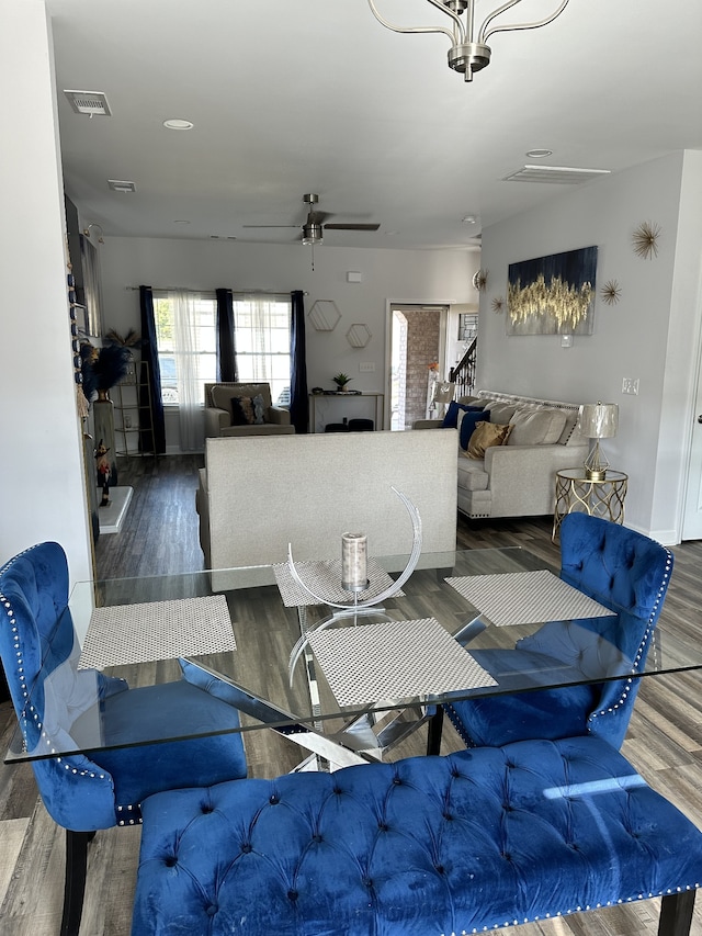 dining space with dark hardwood / wood-style floors and ceiling fan