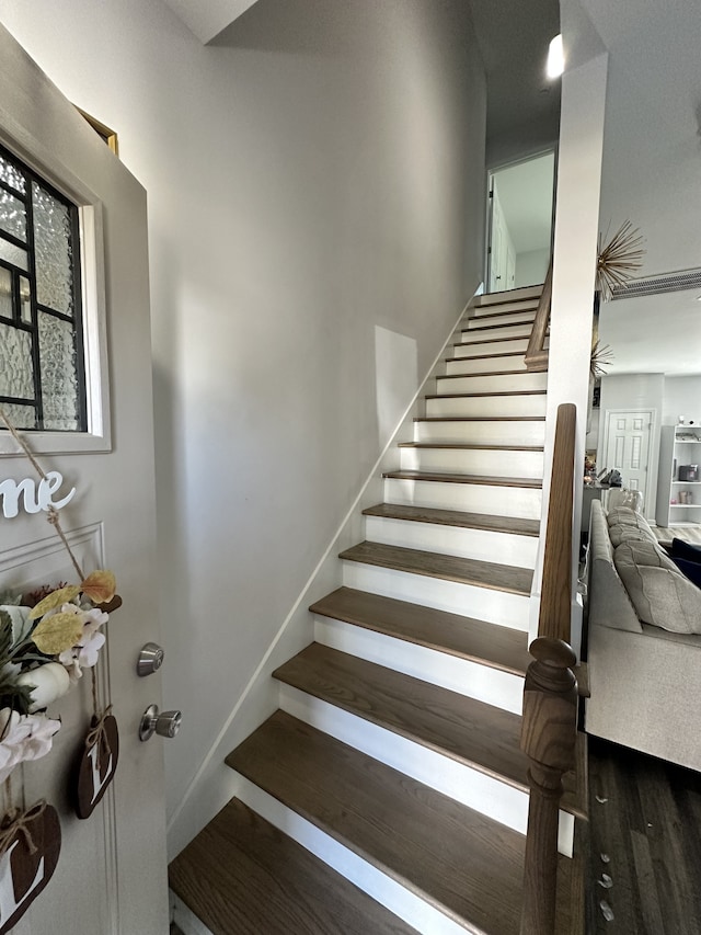 stairway with hardwood / wood-style flooring