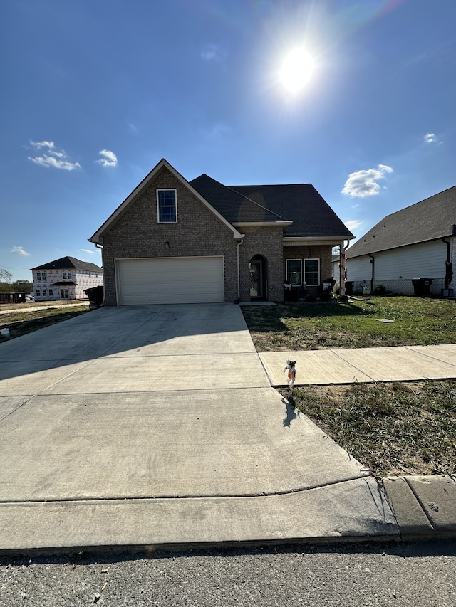 view of front facade featuring a front yard and a garage