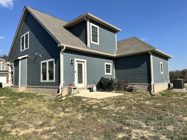 back of property featuring a patio, central AC unit, and a lawn