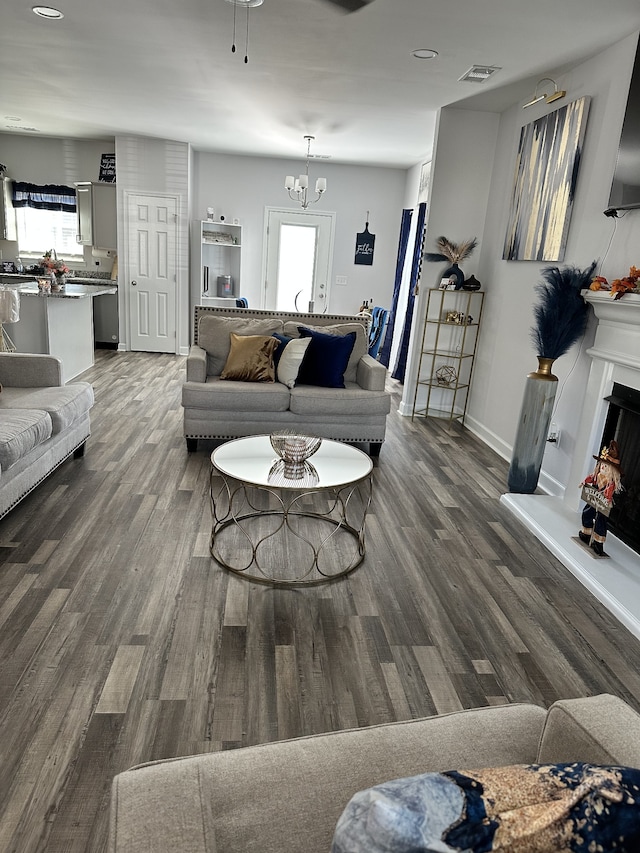 living room featuring hardwood / wood-style floors and a notable chandelier