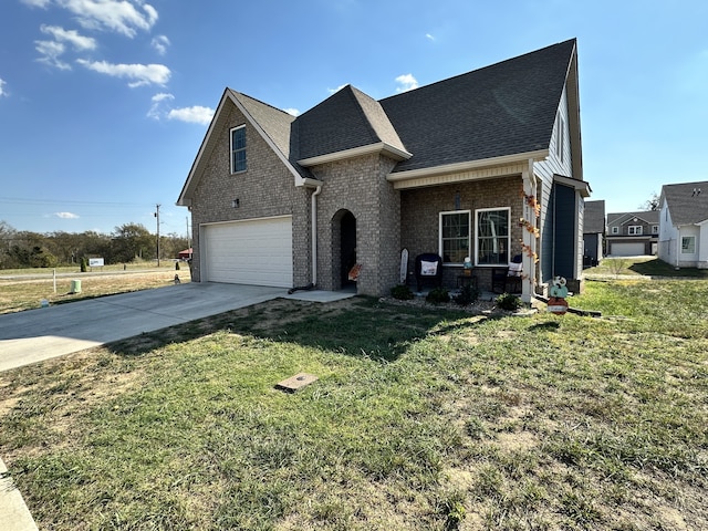 view of front of property with a front yard and a garage