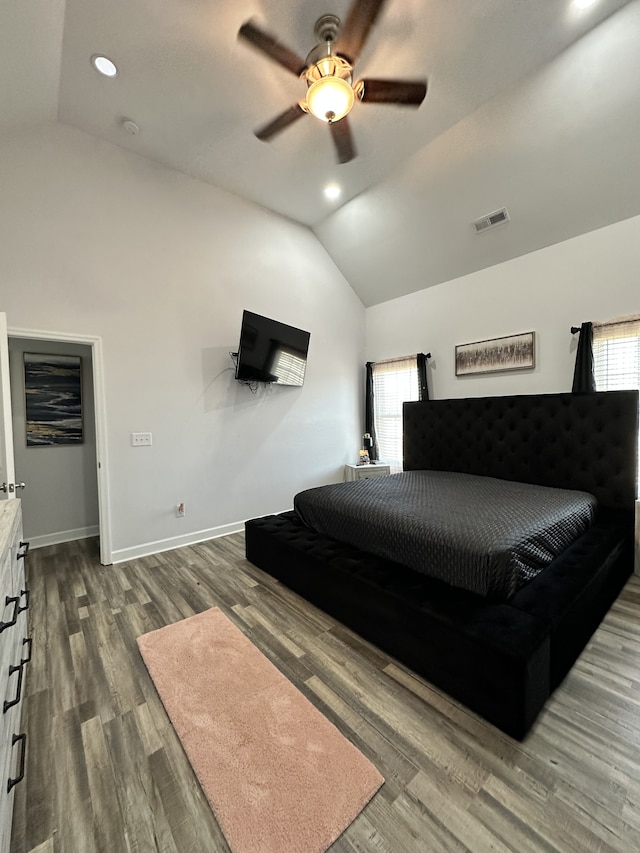 bedroom featuring multiple windows, ceiling fan, wood-type flooring, and vaulted ceiling