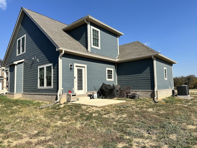 rear view of house featuring a patio area, a yard, and cooling unit