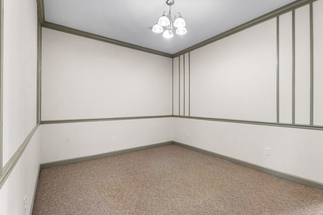 empty room with a notable chandelier, ornamental molding, and carpet floors