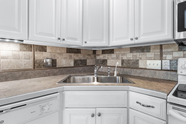 kitchen featuring white appliances, tasteful backsplash, sink, and white cabinets