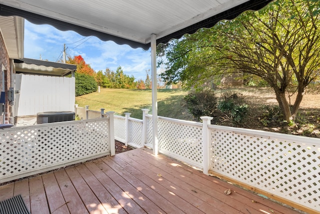 deck featuring central air condition unit and a yard