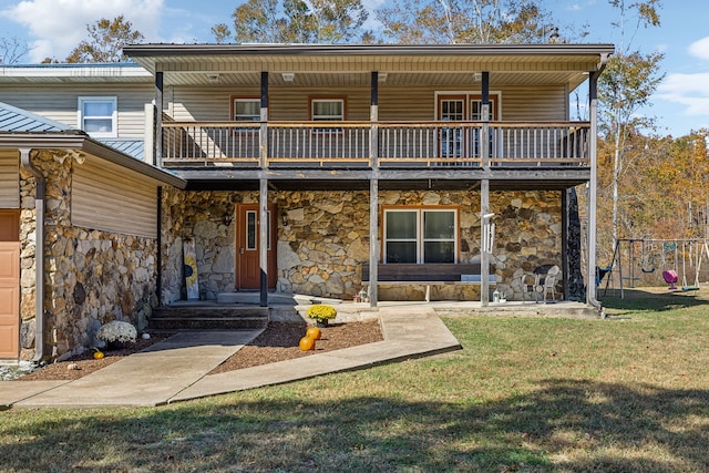 rear view of house with a yard and a balcony