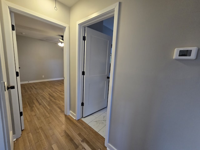 hallway with light hardwood / wood-style flooring