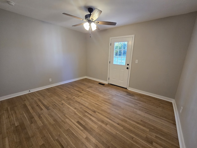 unfurnished room featuring hardwood / wood-style flooring and ceiling fan