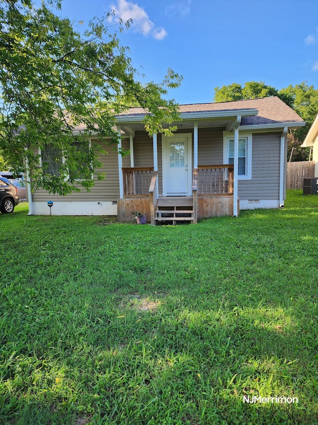 view of front of house with cooling unit, covered porch, and a front yard