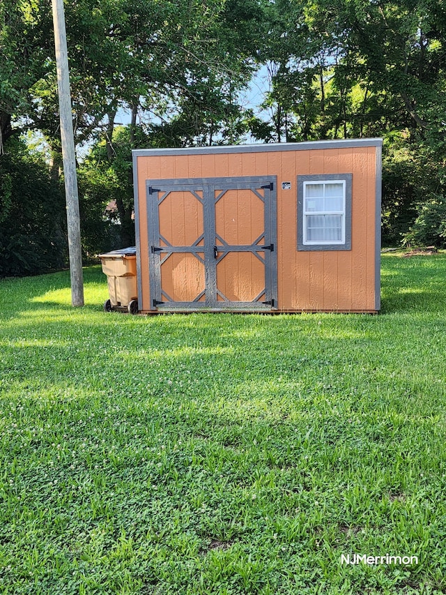 view of outdoor structure featuring a lawn