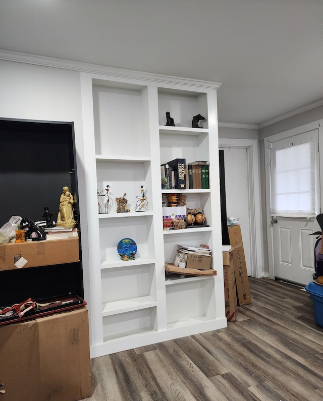 interior details featuring hardwood / wood-style flooring, built in shelves, and ornamental molding