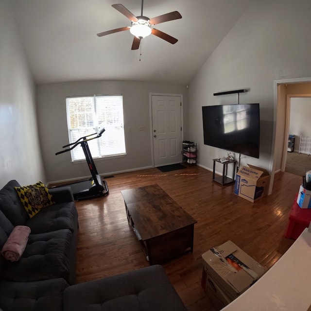 living room featuring dark hardwood / wood-style floors, high vaulted ceiling, and ceiling fan