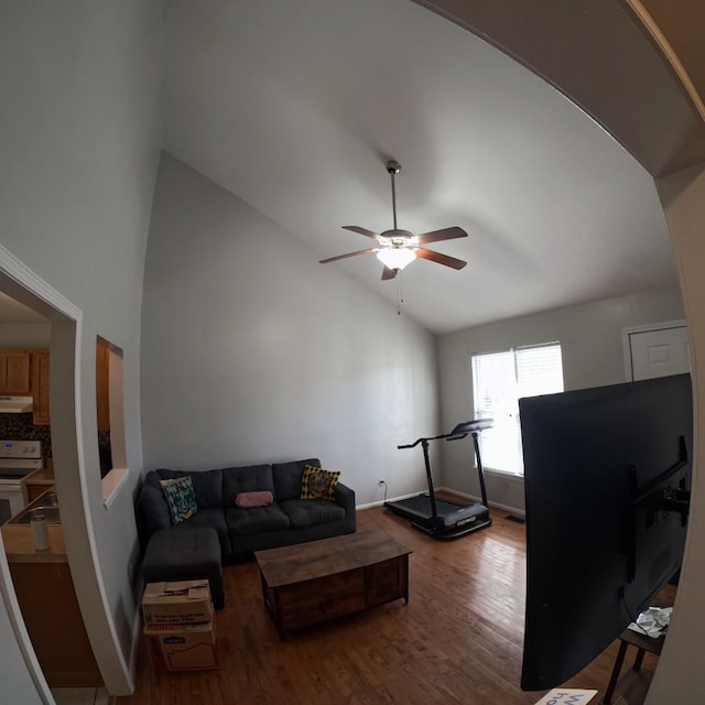 living room featuring hardwood / wood-style floors, ceiling fan, and vaulted ceiling