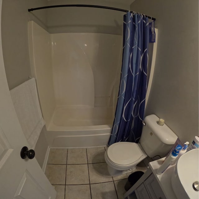 bathroom with tile patterned flooring, shower / bath combo, and toilet