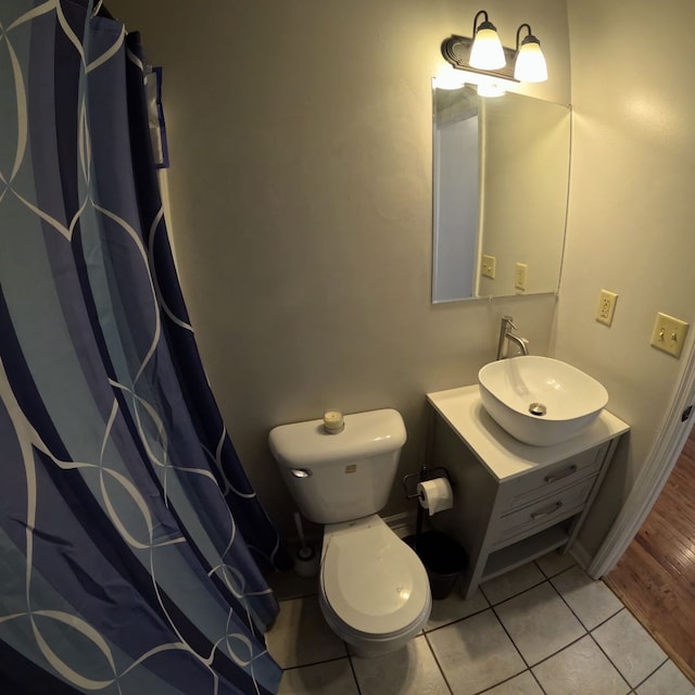 bathroom with hardwood / wood-style floors, vanity, and toilet