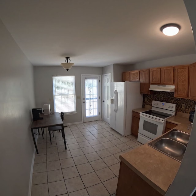 kitchen featuring backsplash, sink, light tile patterned flooring, and white appliances