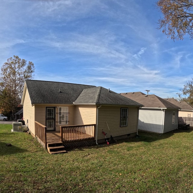 back of property with a yard, a deck, and cooling unit