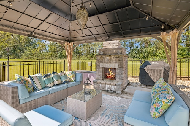 view of patio featuring a gazebo, an outdoor living space with a fireplace, and a grill