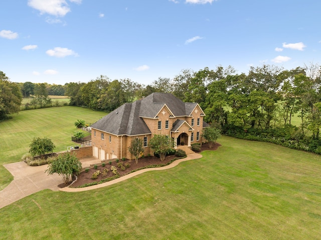 view of front of house with a garage and a front lawn