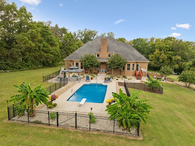 view of swimming pool featuring a patio, a gazebo, a lawn, and a diving board