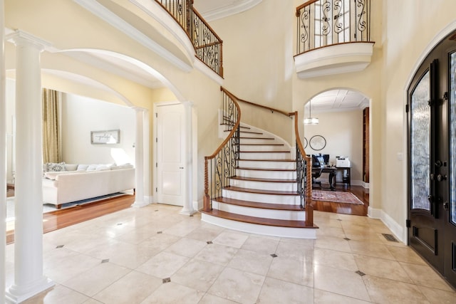 2971 Spanntown Rd, Arrington, TN 37014 - tiled foyer entrance featuring arched walkways, decorative columns, stairway, crown molding, and a towering ceiling