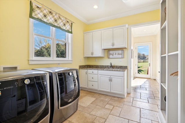 washroom with separate washer and dryer, sink, crown molding, and cabinets