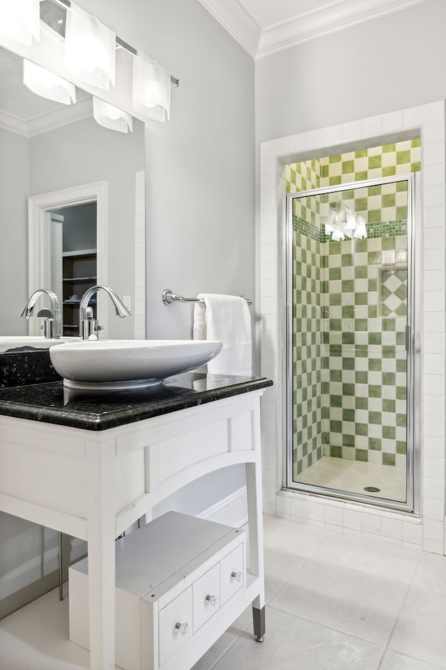 bathroom featuring a shower with door, crown molding, tile patterned flooring, and vanity