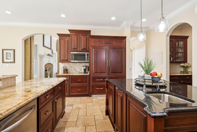 2971 Spanntown Rd, Arrington, TN 37014 - kitchen with stainless steel appliances, arched walkways, dark brown cabinets, hanging light fixtures, and ornamental molding