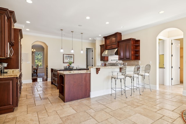 kitchen with ventilation hood, ornamental molding, decorative backsplash, decorative light fixtures, and kitchen peninsula