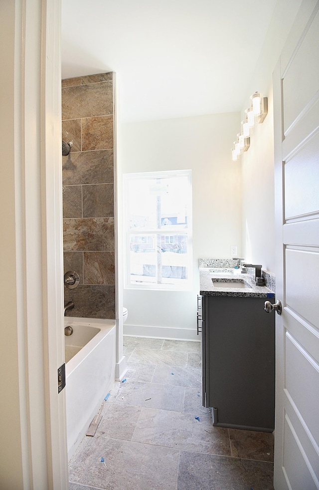 full bathroom featuring vanity, toilet, and tiled shower / bath