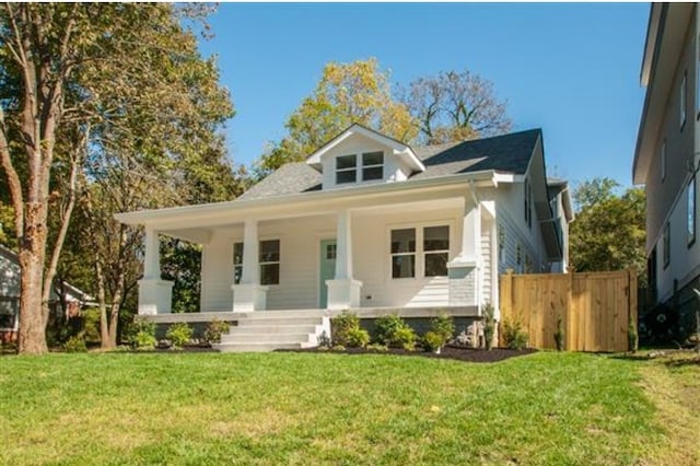 bungalow-style house featuring a front yard and covered porch