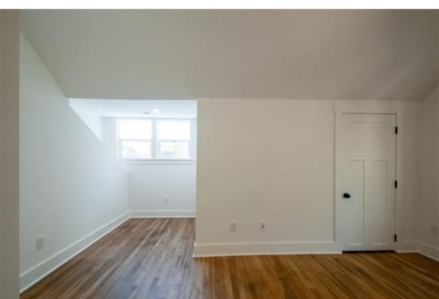 bonus room with vaulted ceiling and wood-type flooring