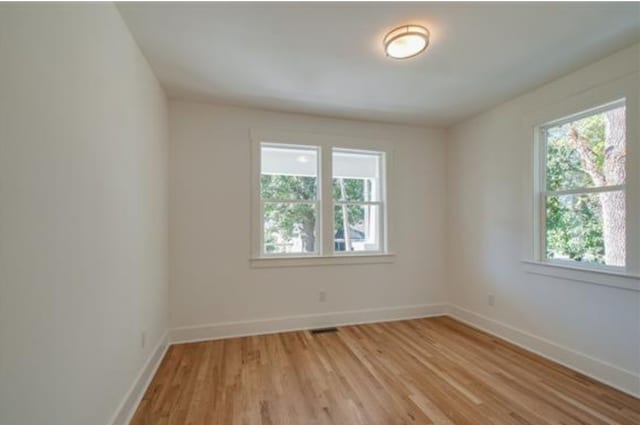 spare room with light hardwood / wood-style floors