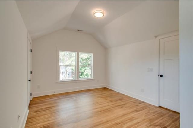 interior space with lofted ceiling and light hardwood / wood-style flooring