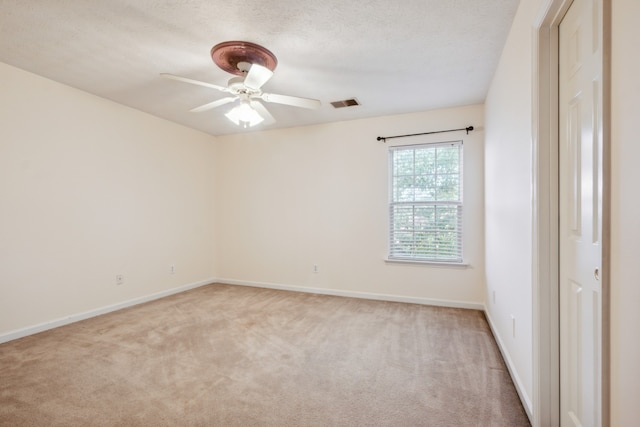 unfurnished room with light carpet, a textured ceiling, and ceiling fan