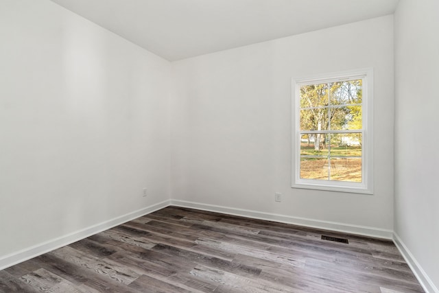 empty room with dark wood-type flooring