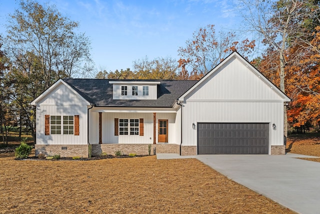 modern farmhouse style home with a porch and a garage