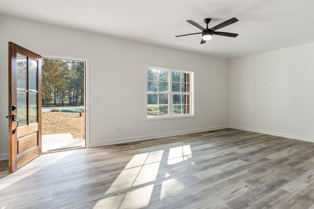 empty room with light hardwood / wood-style flooring and ceiling fan