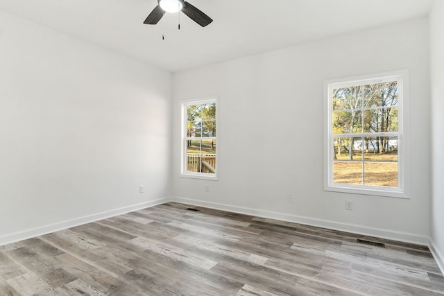 spare room featuring light hardwood / wood-style floors and ceiling fan