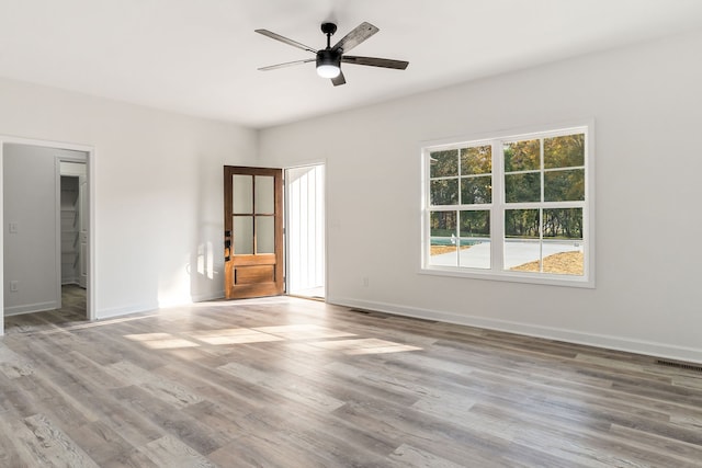 spare room with light hardwood / wood-style floors and ceiling fan