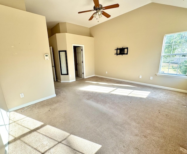 carpeted empty room featuring ceiling fan and high vaulted ceiling