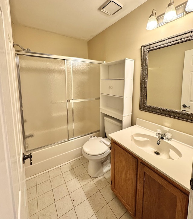 full bathroom with vanity, tile patterned floors, toilet, and combined bath / shower with glass door