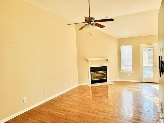 unfurnished living room with ceiling fan, lofted ceiling, and light hardwood / wood-style floors