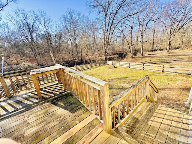 wooden deck featuring a lawn