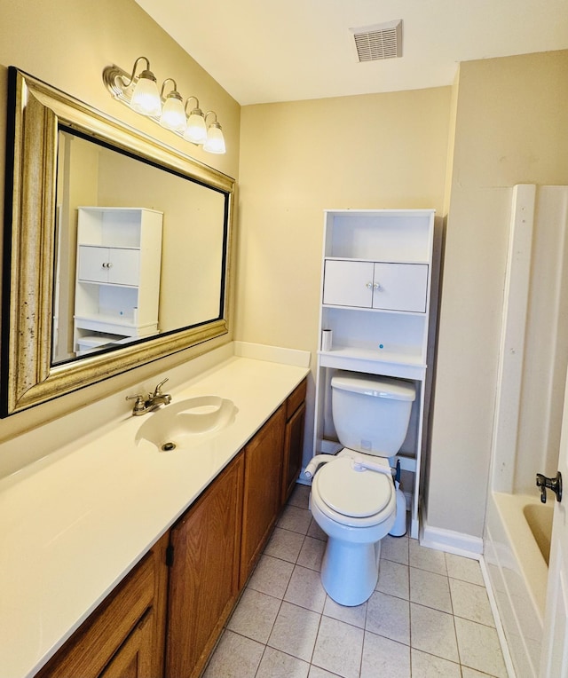 bathroom with vanity, a washtub, tile patterned floors, and toilet