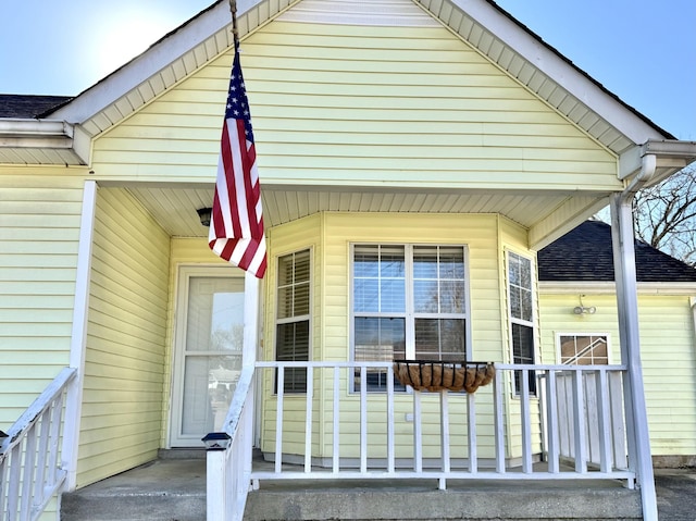 view of exterior entry featuring covered porch